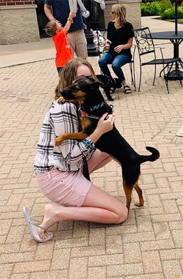 girl hugging dog at The Shoppes at Grand Prairie in Peoria, IL