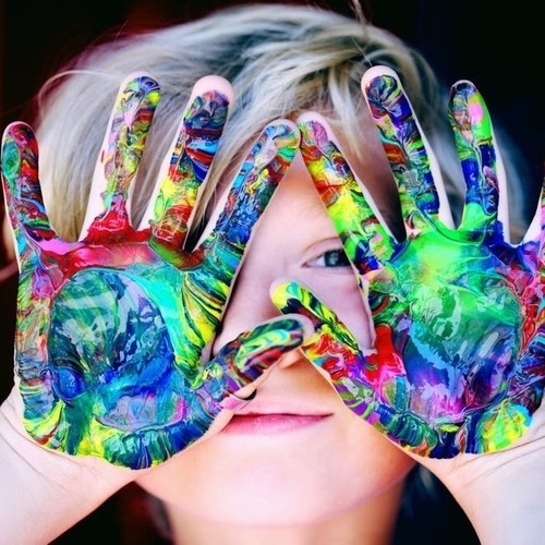 Child with tie dye painted hands