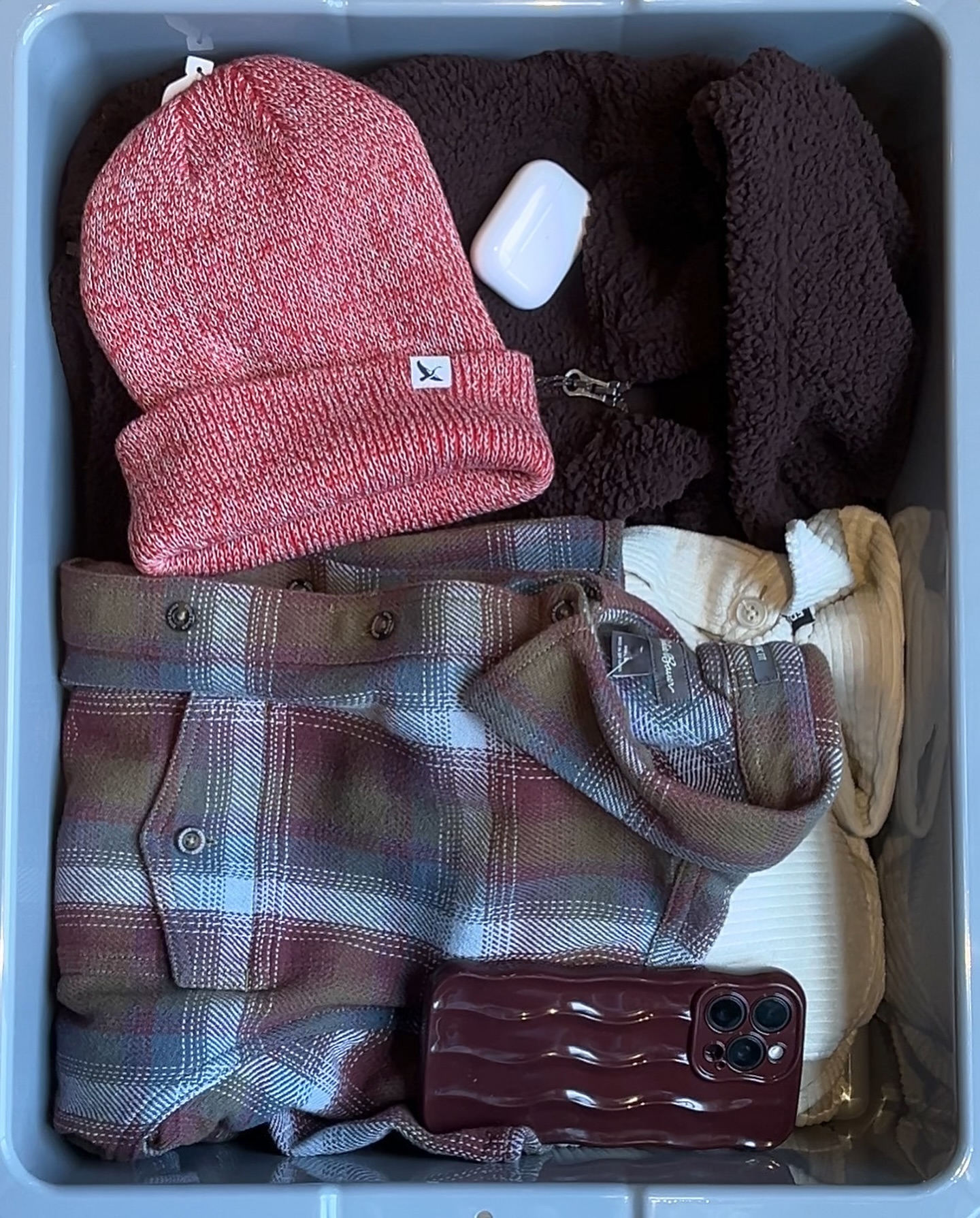 EDDIE BAUER a spread of clothing including a beanie and a flannel shirt